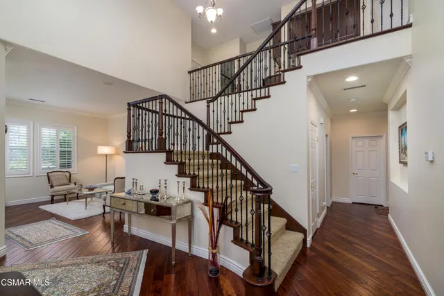 a view of entryway and dining room and hall with wooden floor