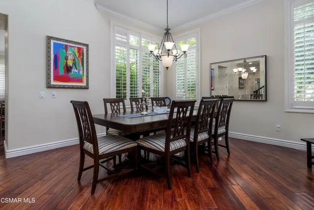a view of a dining room with furniture wooden floor and chandelier