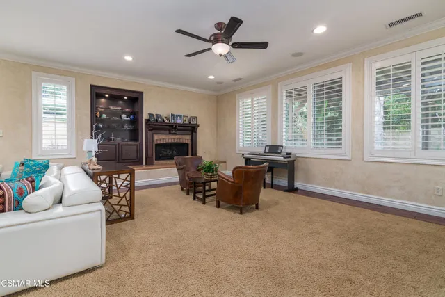 a living room with furniture and fireplace