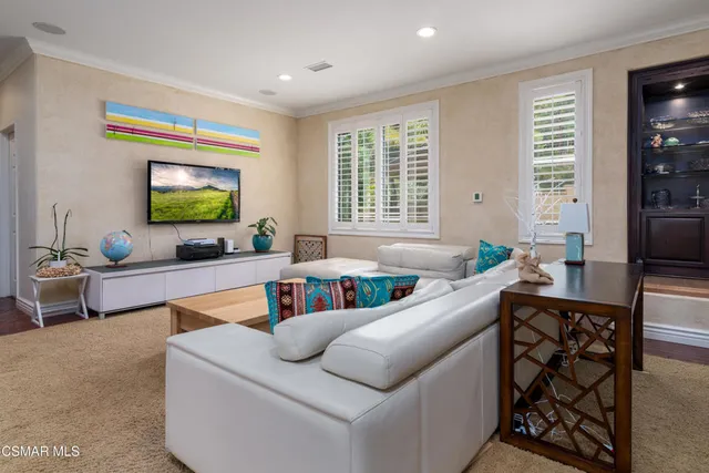 a living room with furniture and flat screen tv
