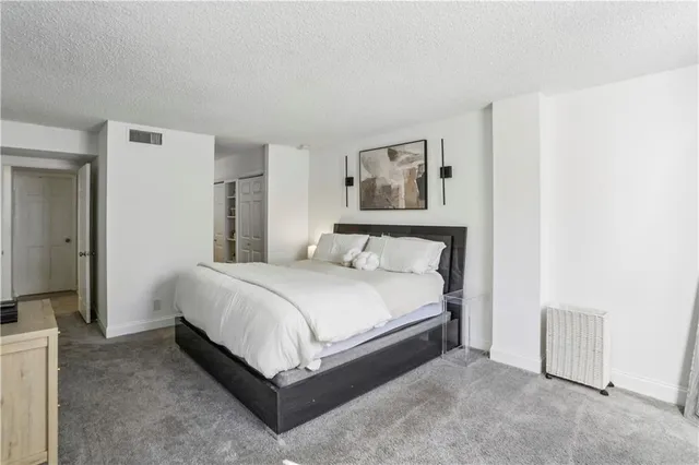 a bedroom with a bed and a wall painting