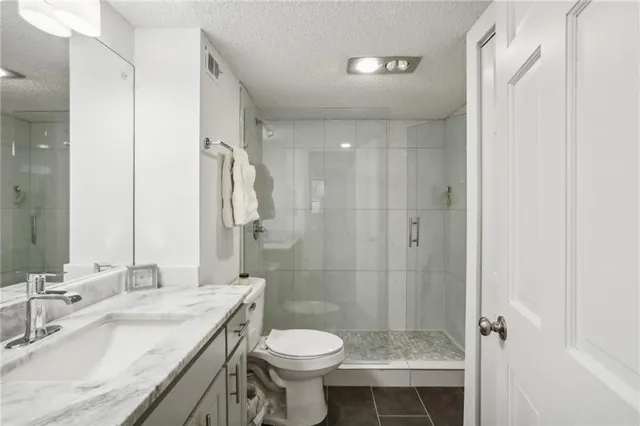 a bathroom with a double vanity sink toilet and shower