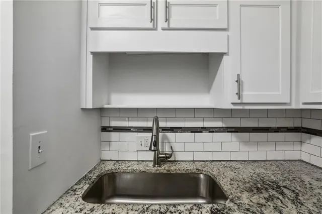a kitchen with a sink and cabinets