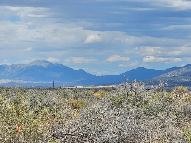 a view of mountain with sunset in background