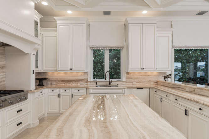 620 Golden Harbour Drive Boca Raton, FL 33432 - Photo 25 of 45 a large white kitchen with granite countertop a stove a sink dishwasher and white cabinets with wooden floor