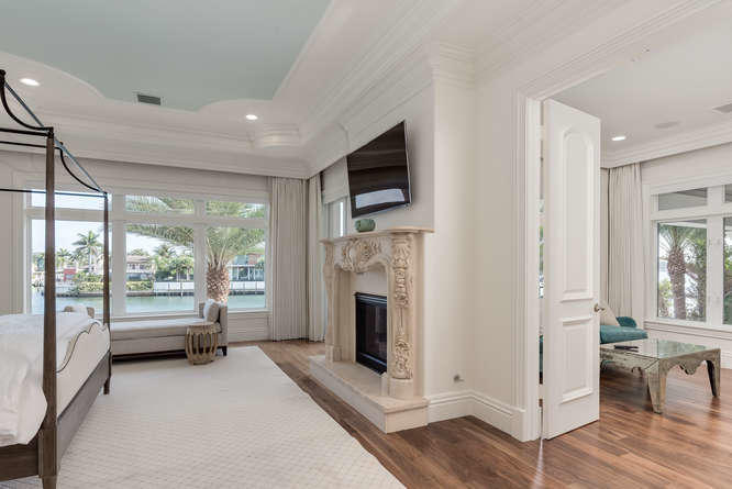 620 Golden Harbour Drive Boca Raton, FL 33432 - Photo 32 of 45 a living room with fireplace furniture and a flat screen tv