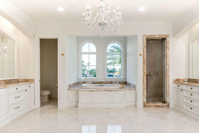 620 Golden Harbour Drive Boca Raton, FL 33432 - Photo 34 of 45 a spacious bathroom with a double vanity sink a mirror and a bathtub