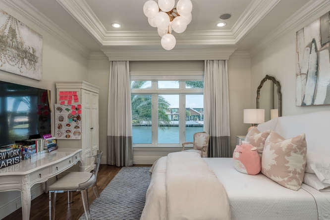 620 Golden Harbour Drive Boca Raton, FL 33432 - Photo 36 of 45 a bedroom with a balcony a bed and a flat screen tv