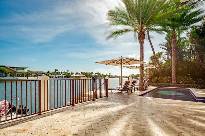 620 Golden Harbour Drive Boca Raton, FL 33432 - Photo 39 of 45 a view of a swimming pool and lounge chairs
