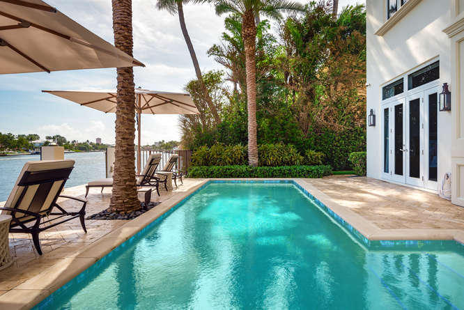 620 Golden Harbour Drive Boca Raton, FL 33432 - Photo 40 of 45 a view of swimming pool with chairs and wooden fence