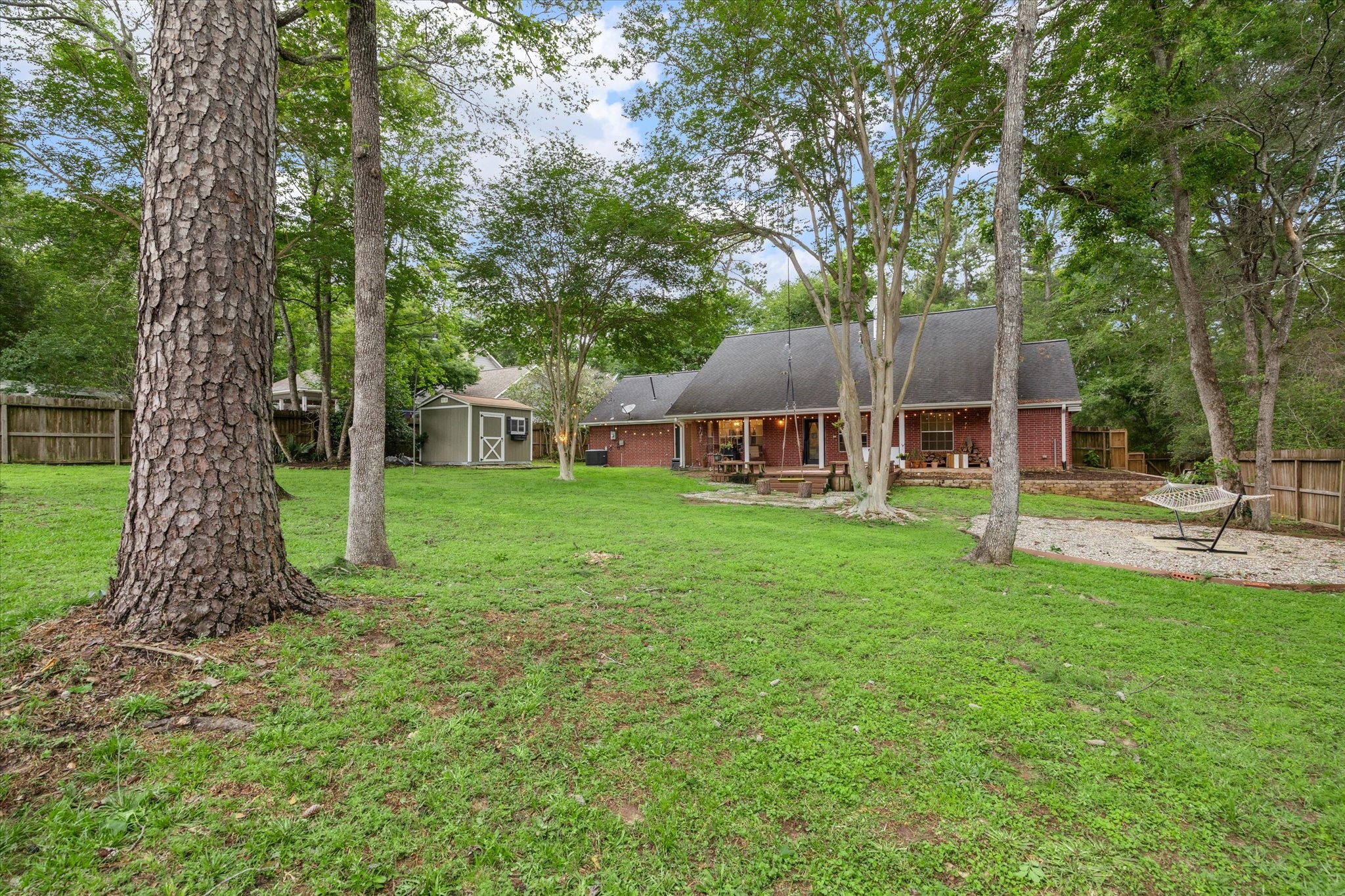 2420 Canter Lane Conroe, TX 77384 - Photo 19 of 24 a view of a house with backyard and a tree