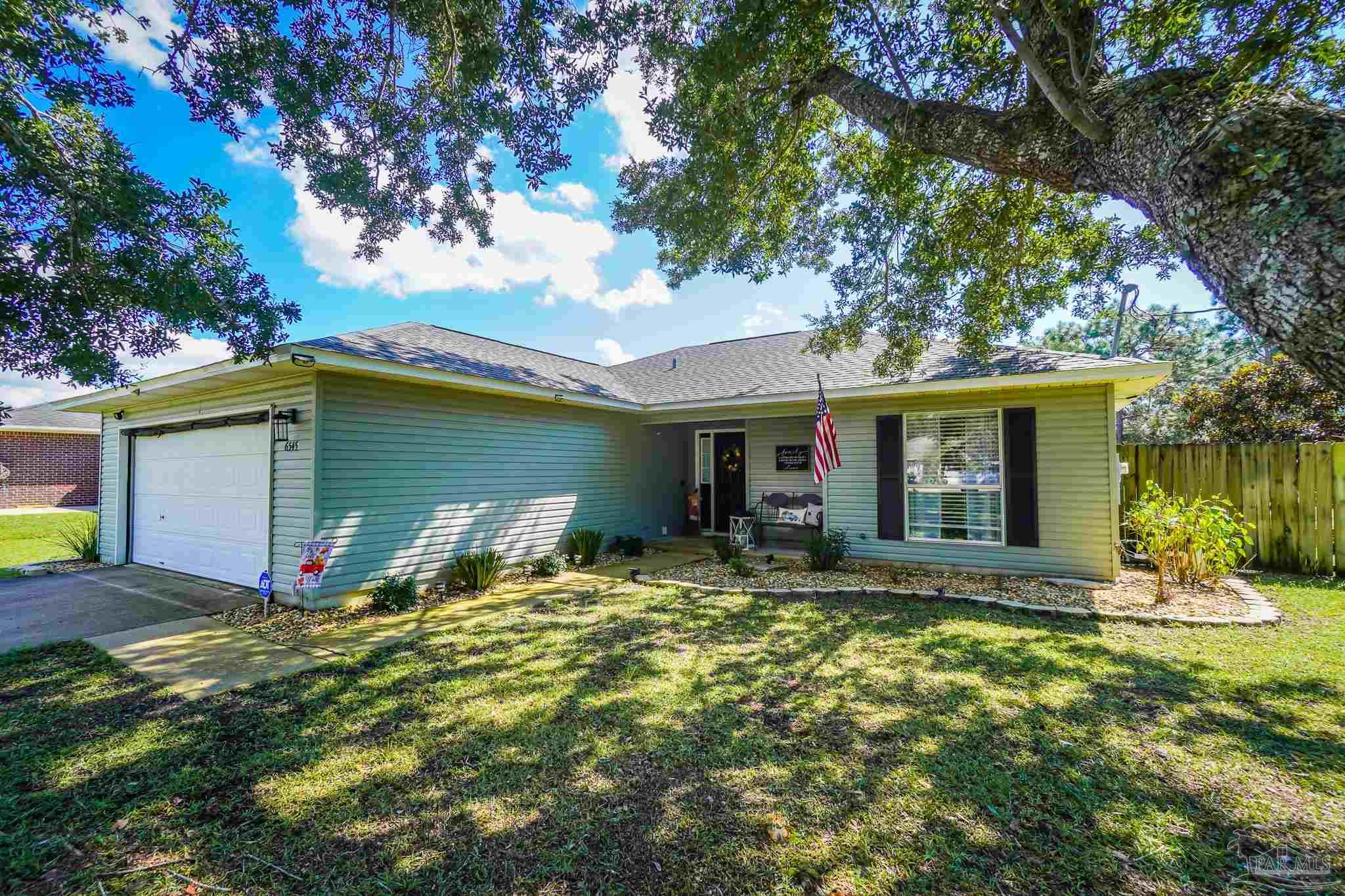 6545 Fern Street Navarre, FL 32566 - Photo 2 of 32 a view of a house with backyard