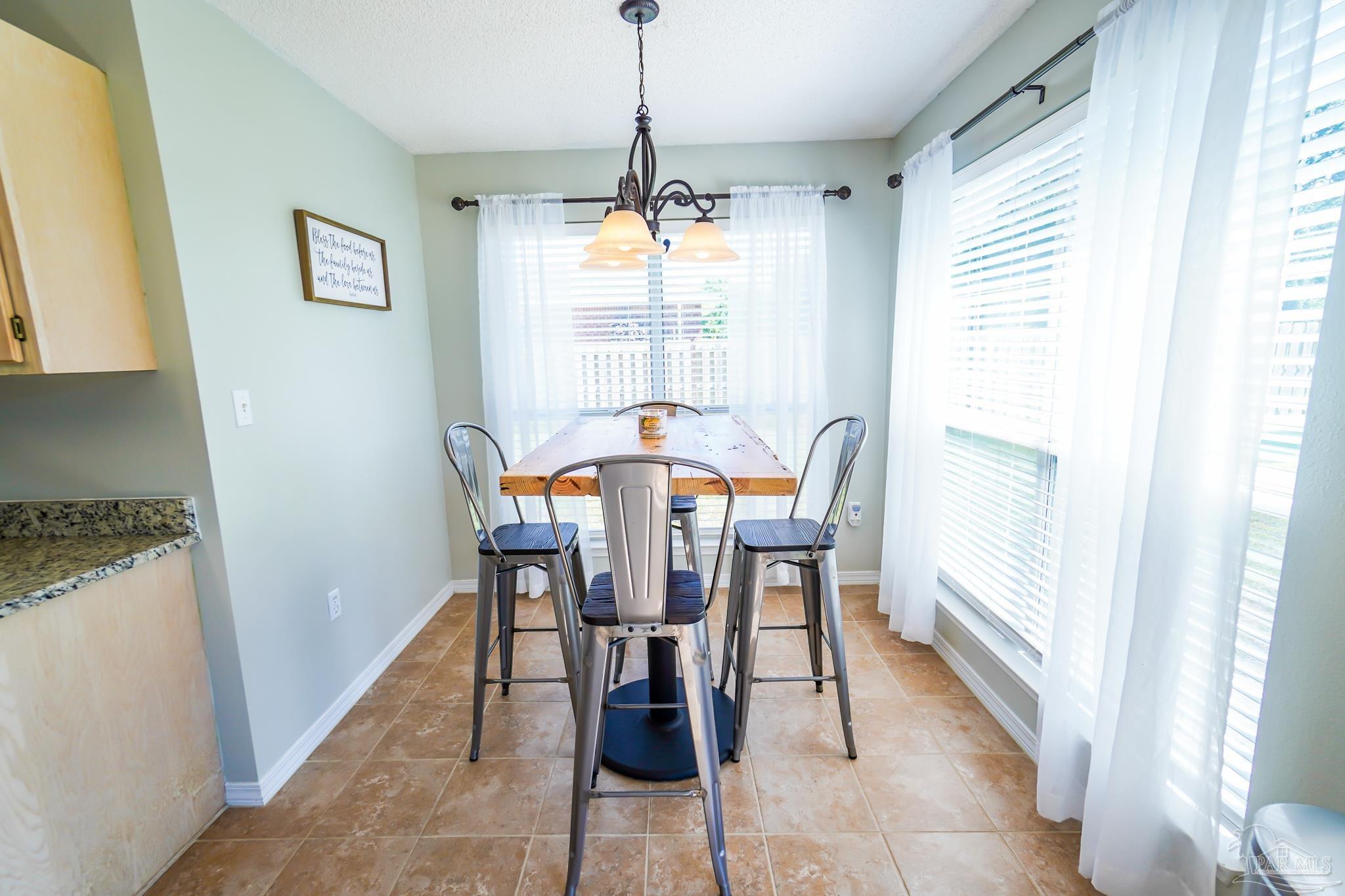 6545 Fern Street Navarre, FL 32566 - Photo 12 of 32 a view of a dining room with furniture window and outside view