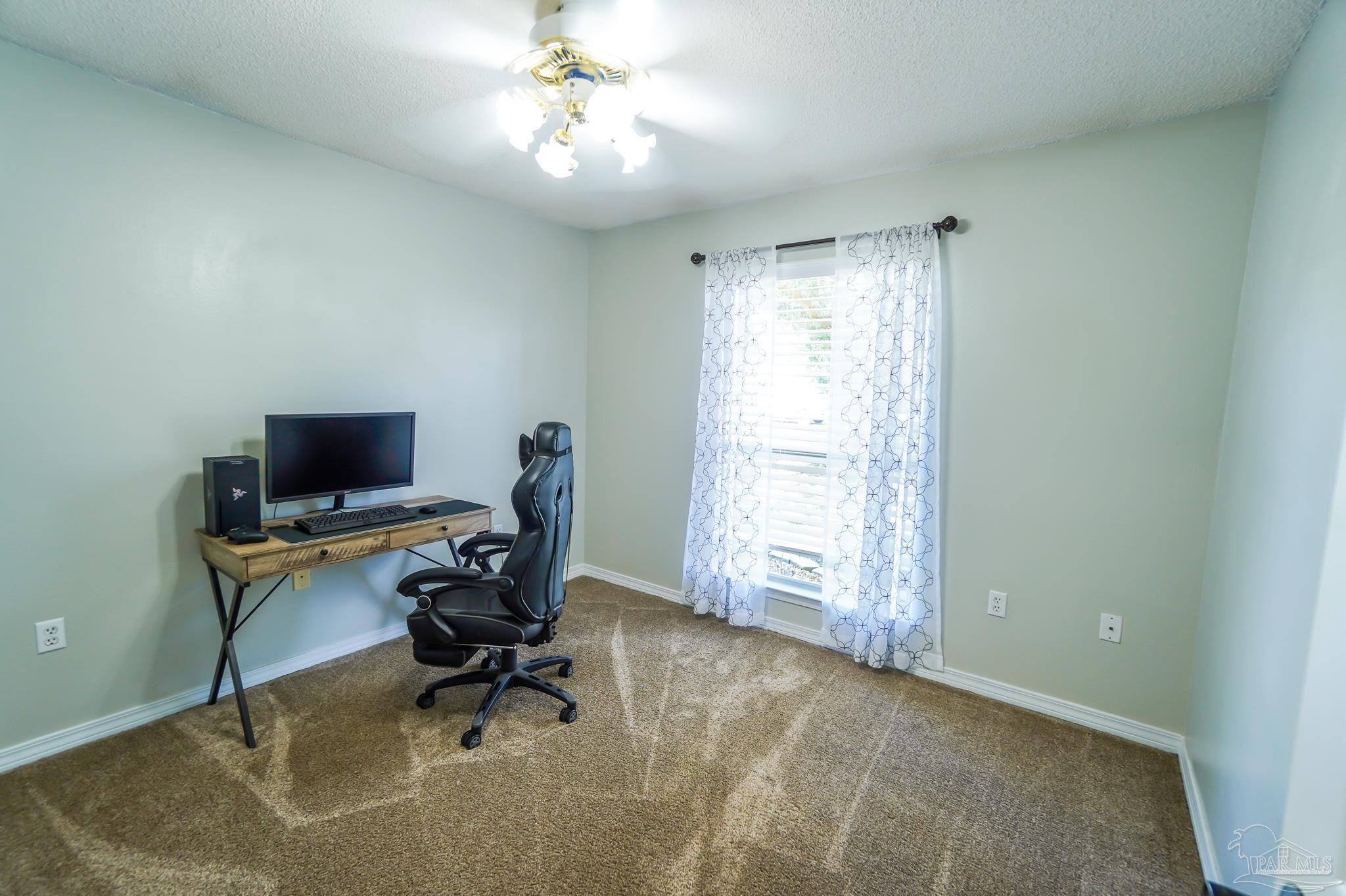 6545 Fern Street Navarre, FL 32566 - Photo 22 of 32 a view of a workspace with furniture and a window