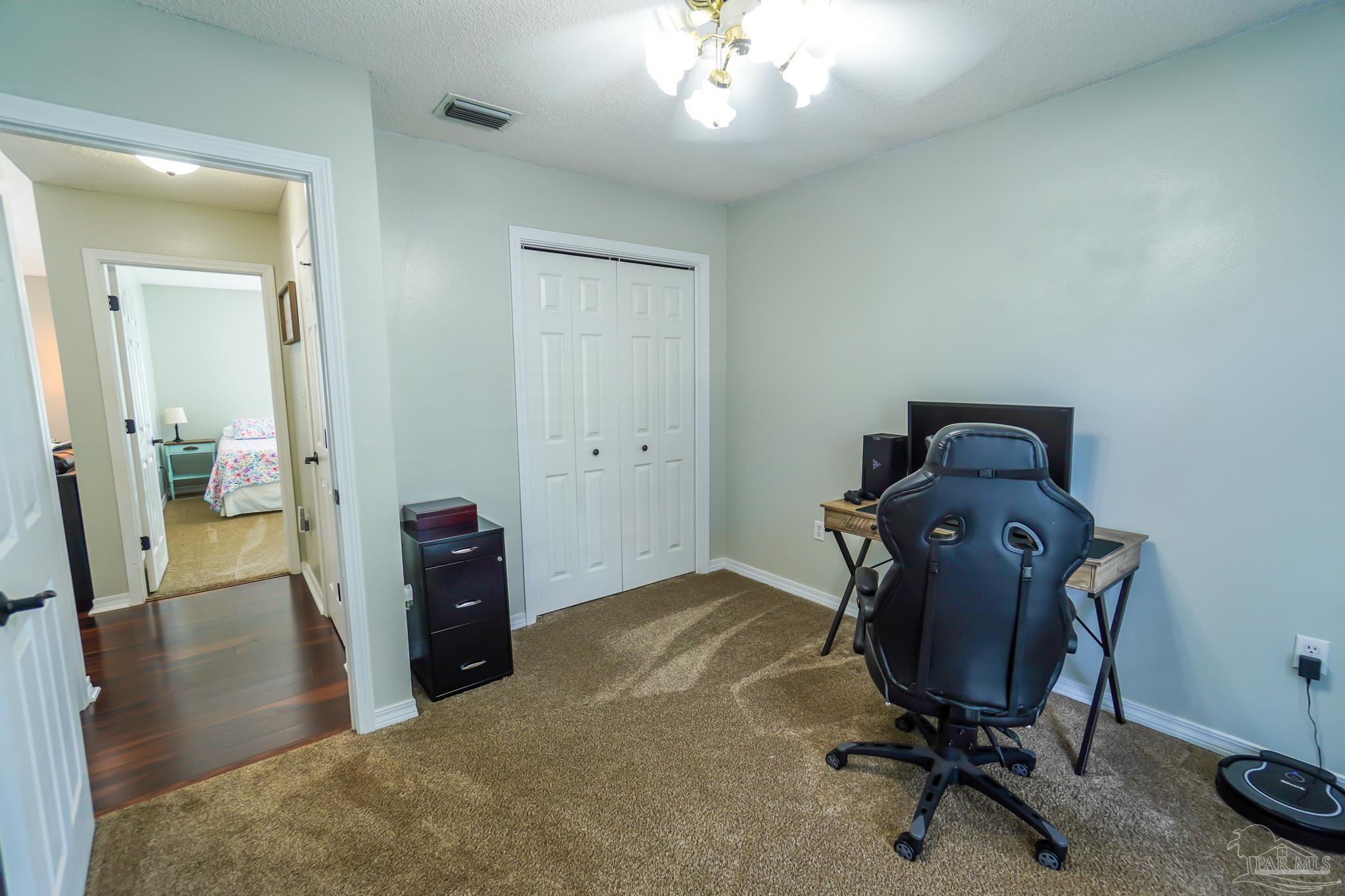 6545 Fern Street Navarre, FL 32566 - Photo 23 of 32 a view of a workspace with furniture and a mirror