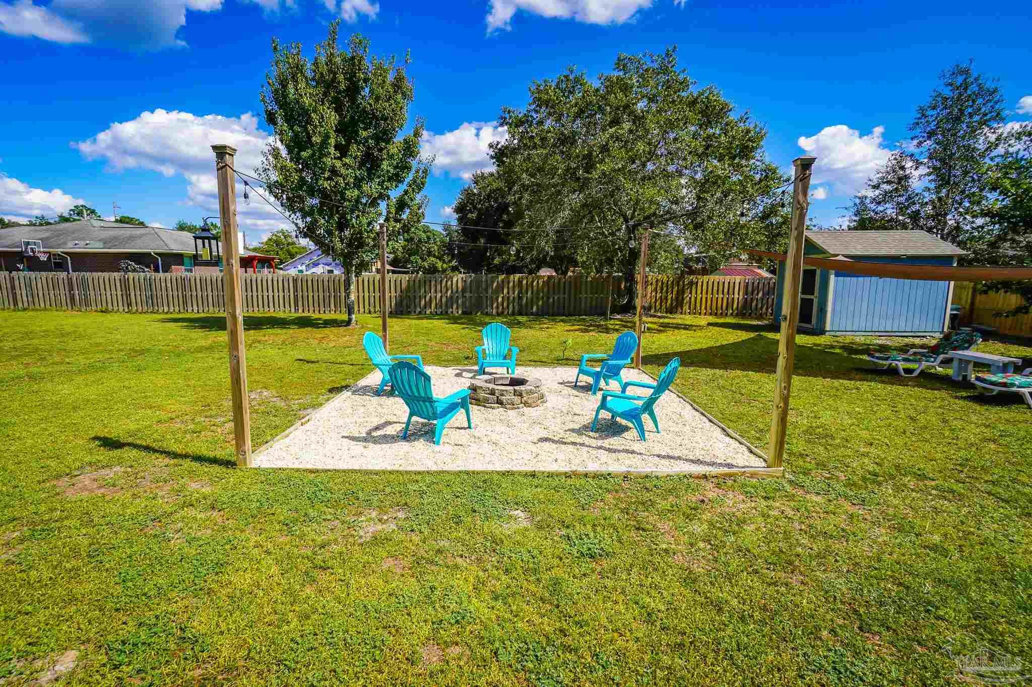 6545 Fern Street Navarre, FL 32566 - Photo 27 of 32 a view of a backyard with swimming pool