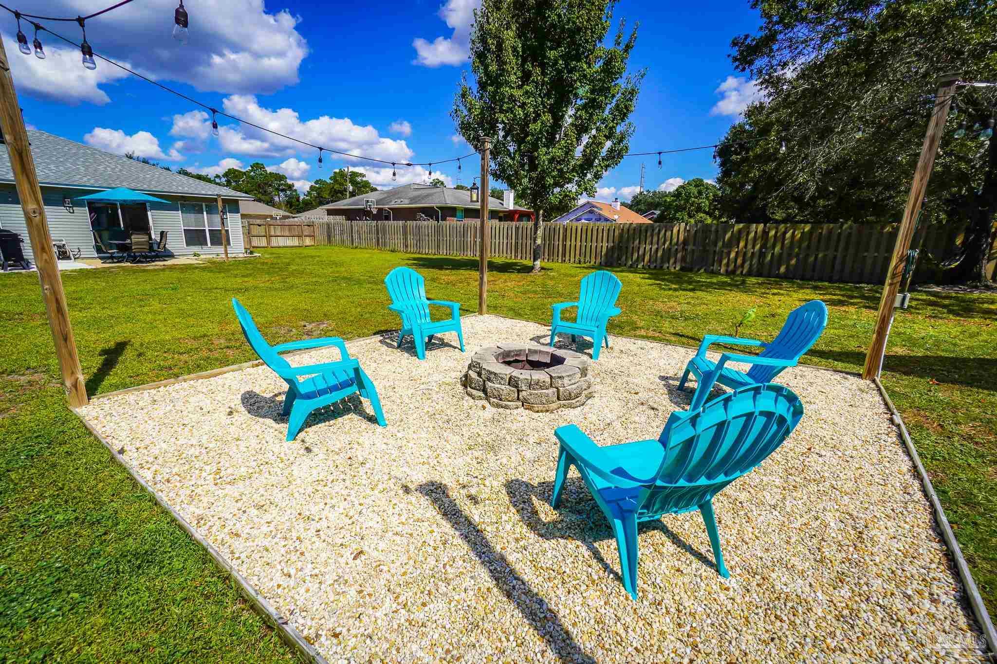 6545 Fern Street Navarre, FL 32566 - Photo 28 of 32 a view of swimming pool with lounge chairs in patio