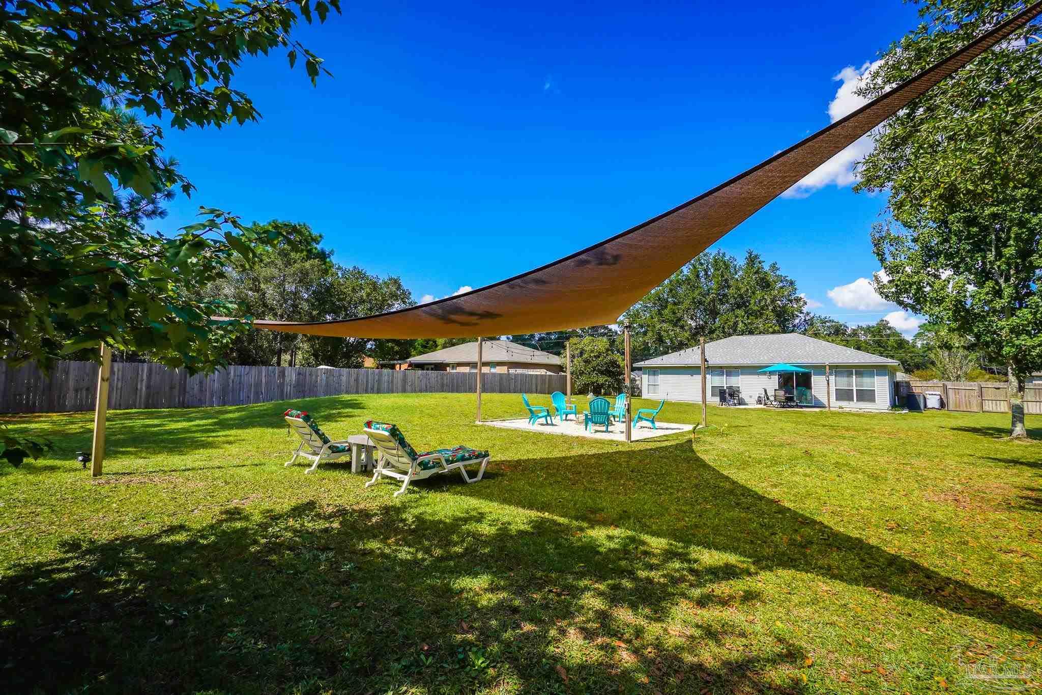 6545 Fern Street Navarre, FL 32566 - Photo 30 of 32 a view of a house with a yard