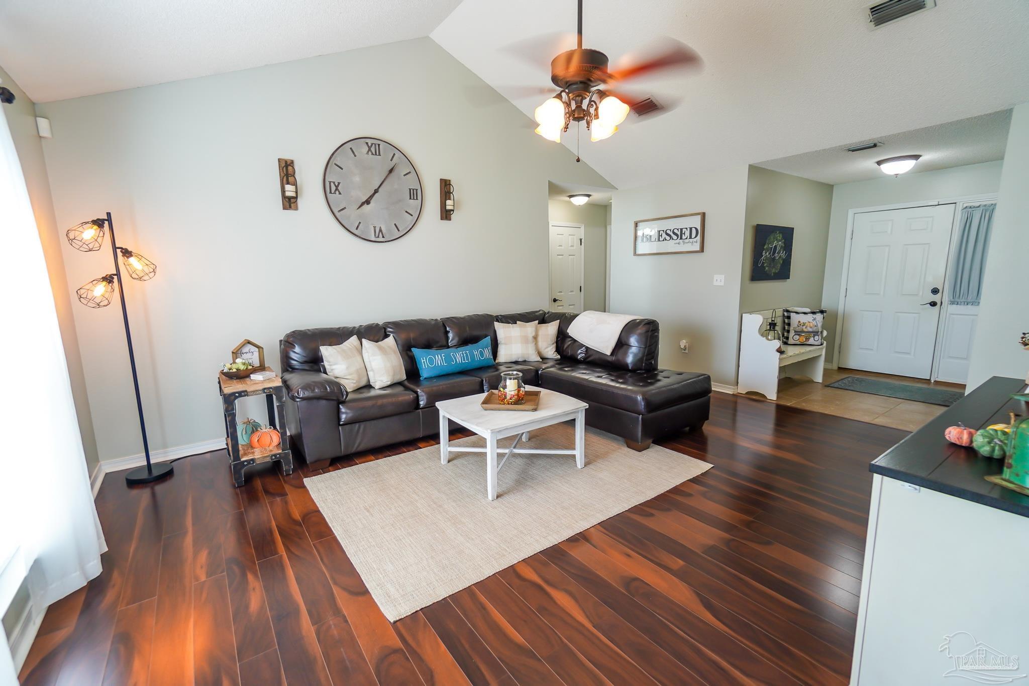 6545 Fern Street Navarre, FL 32566 - Photo 4 of 32 a living room with furniture and a wooden floor
