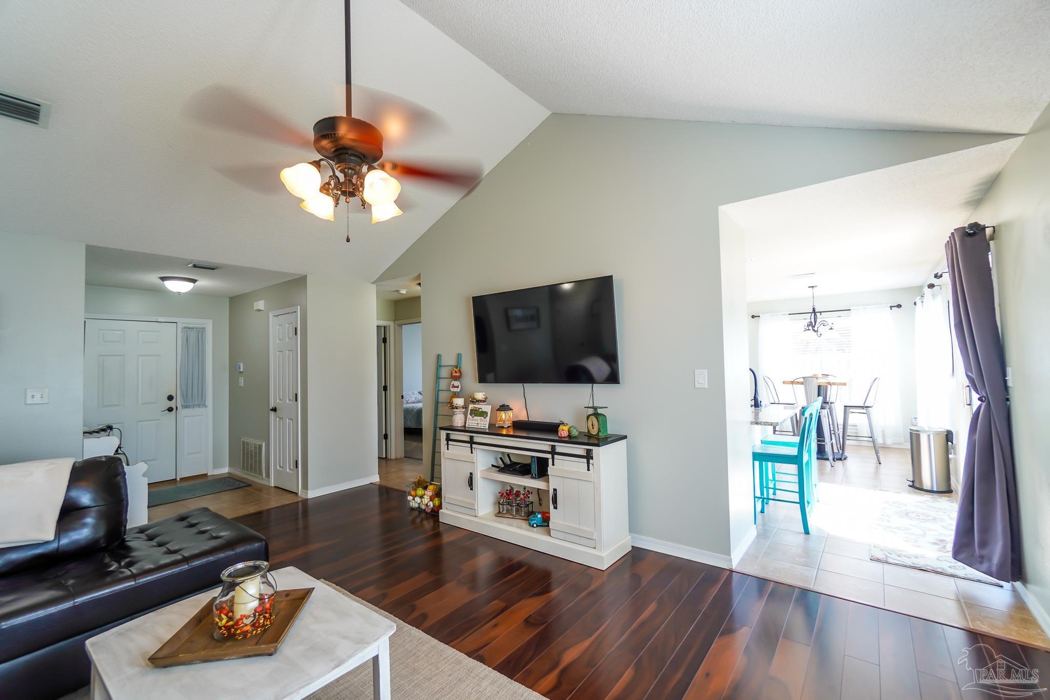 6545 Fern Street Navarre, FL 32566 - Photo 6 of 32 a living room with furniture and a flat screen tv