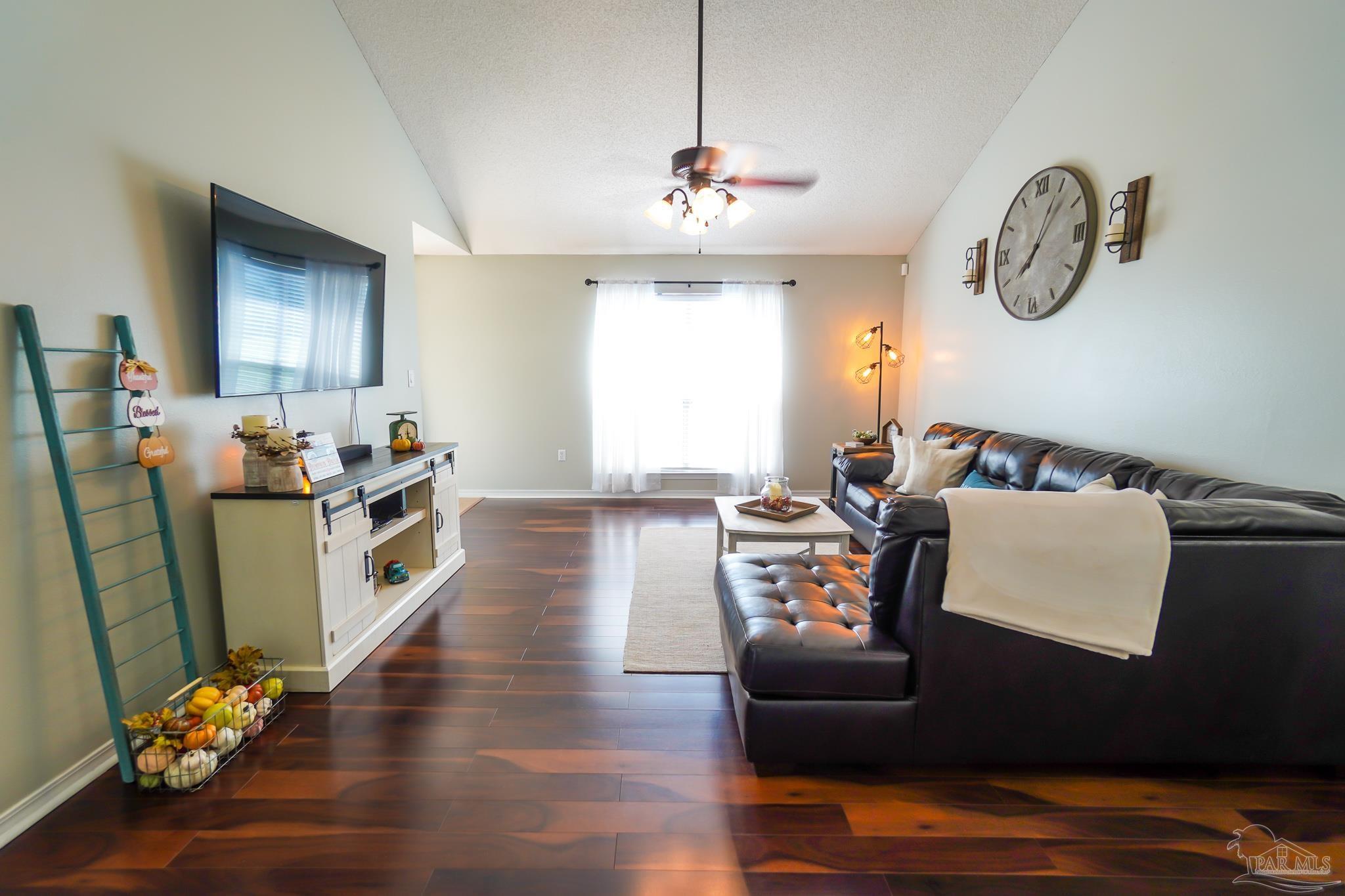 6545 Fern Street Navarre, FL 32566 - Photo 7 of 32 a living room with furniture window and wooden floor