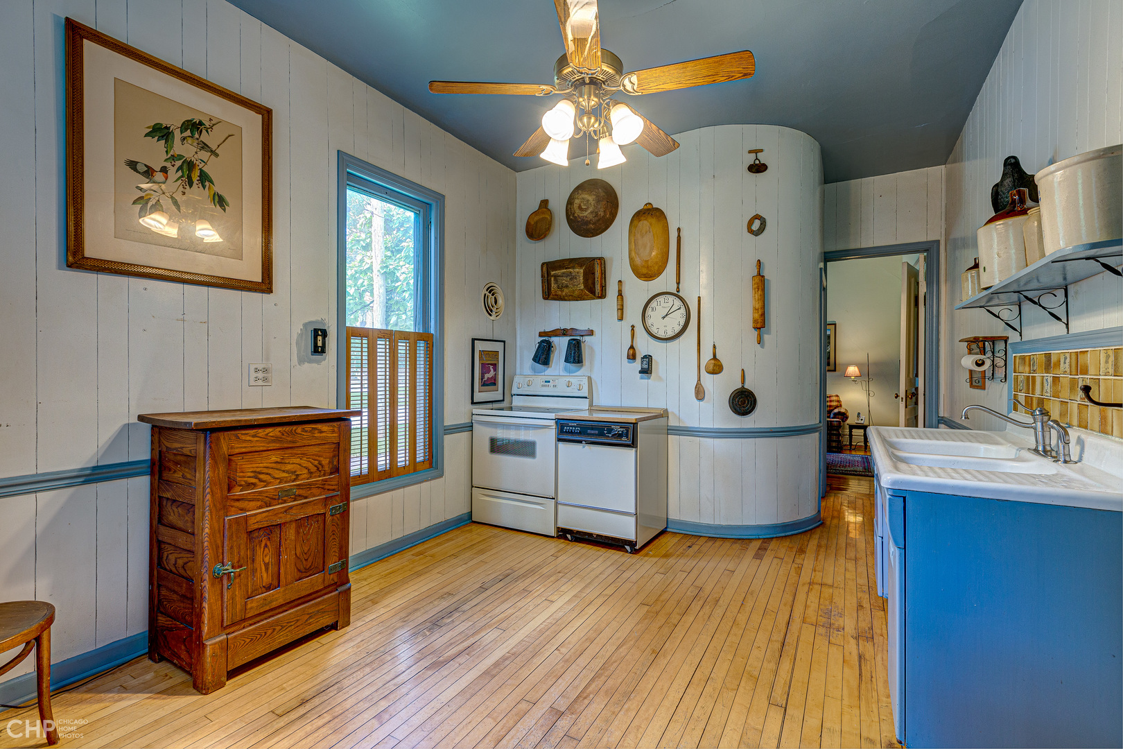 5725 Broadway Road Richmond, IL 60071 - Photo 15 of 26 a kitchen with stainless steel appliances granite countertop a stove a sink dishwasher and a dining table with wooden floor