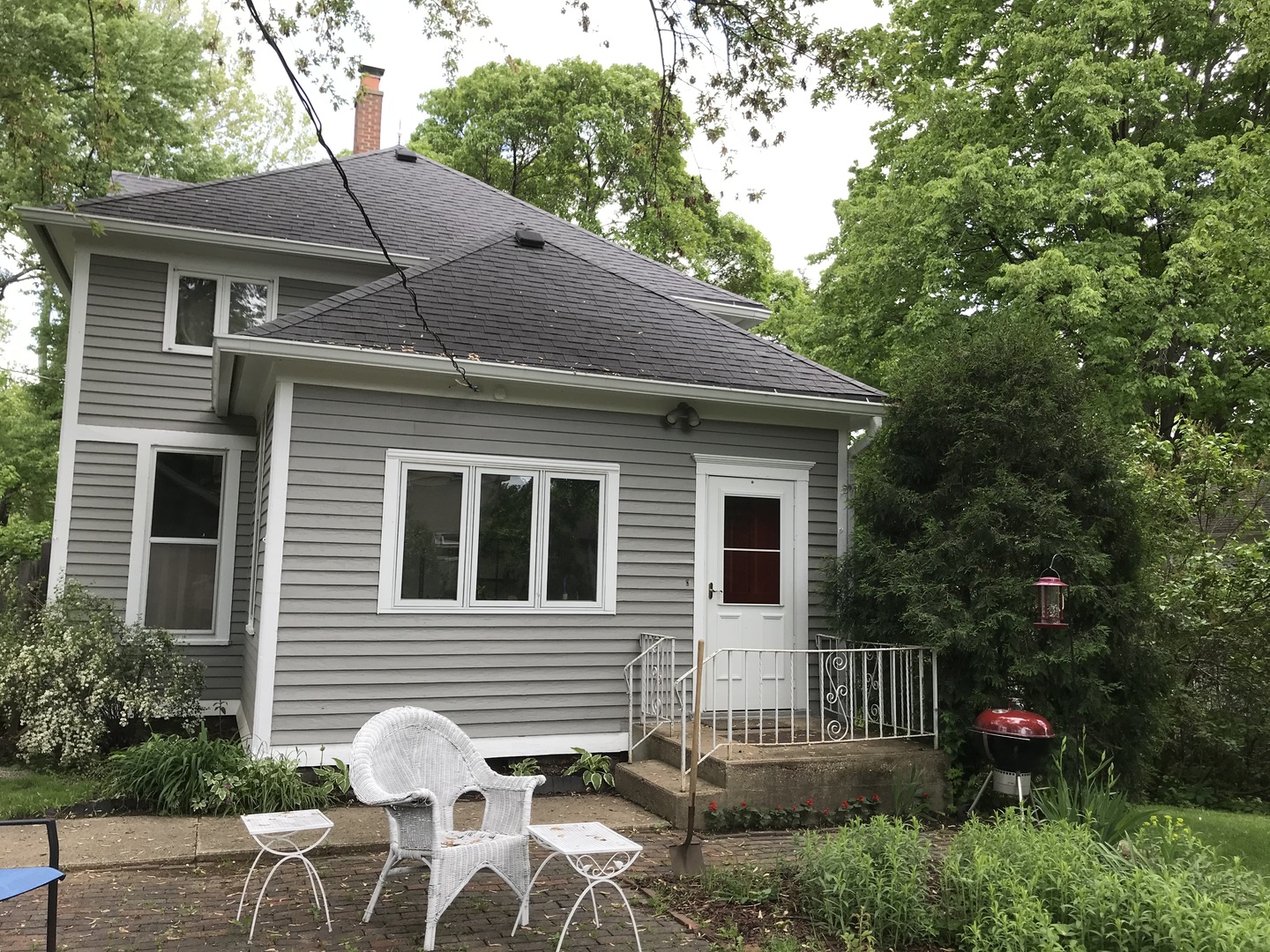 5725 Broadway Road Richmond, IL 60071 - Photo 4 of 26 a backyard of a house with table and chairs and potted plants