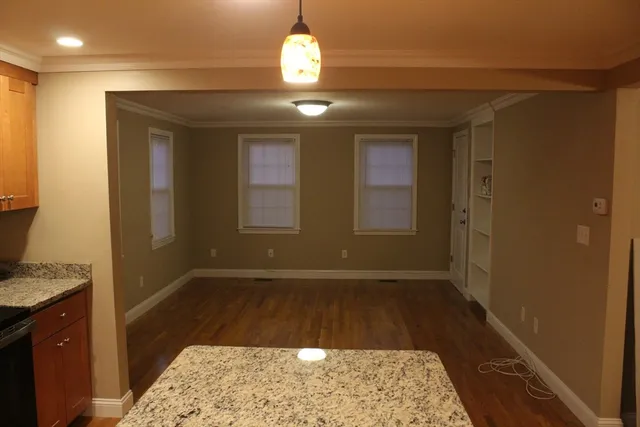 a view of hallway with granite countertop furniture and a rug