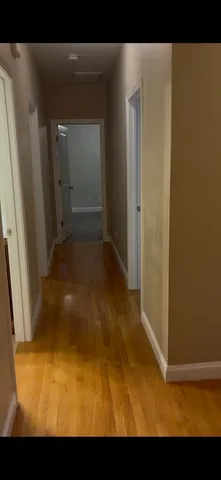 a view of a room with wooden floor