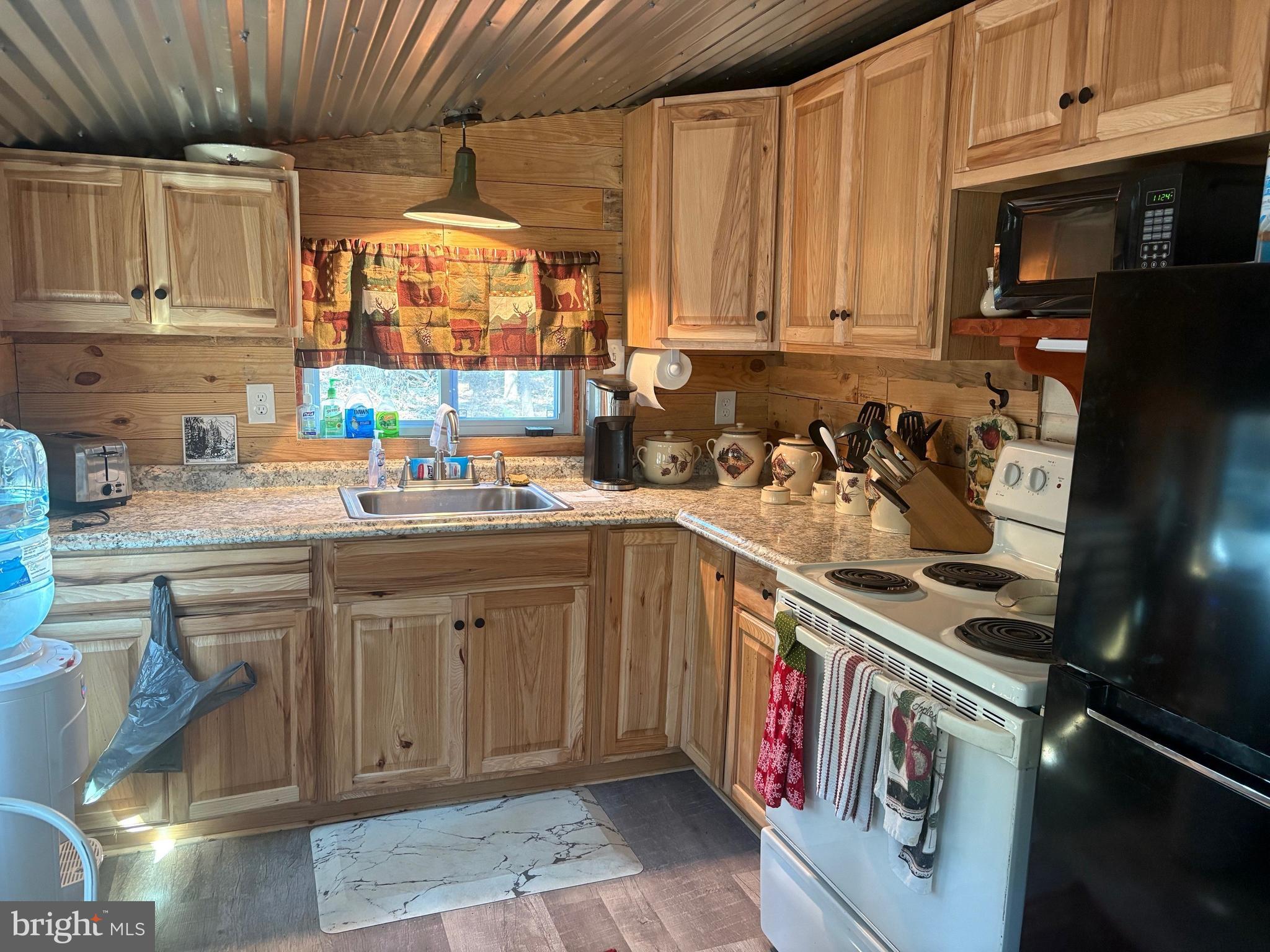 465 Miltonberger Road Orrtanna, PA 17353 - Photo 8 of 13 a kitchen with stainless steel appliances granite countertop a sink stove and cabinets