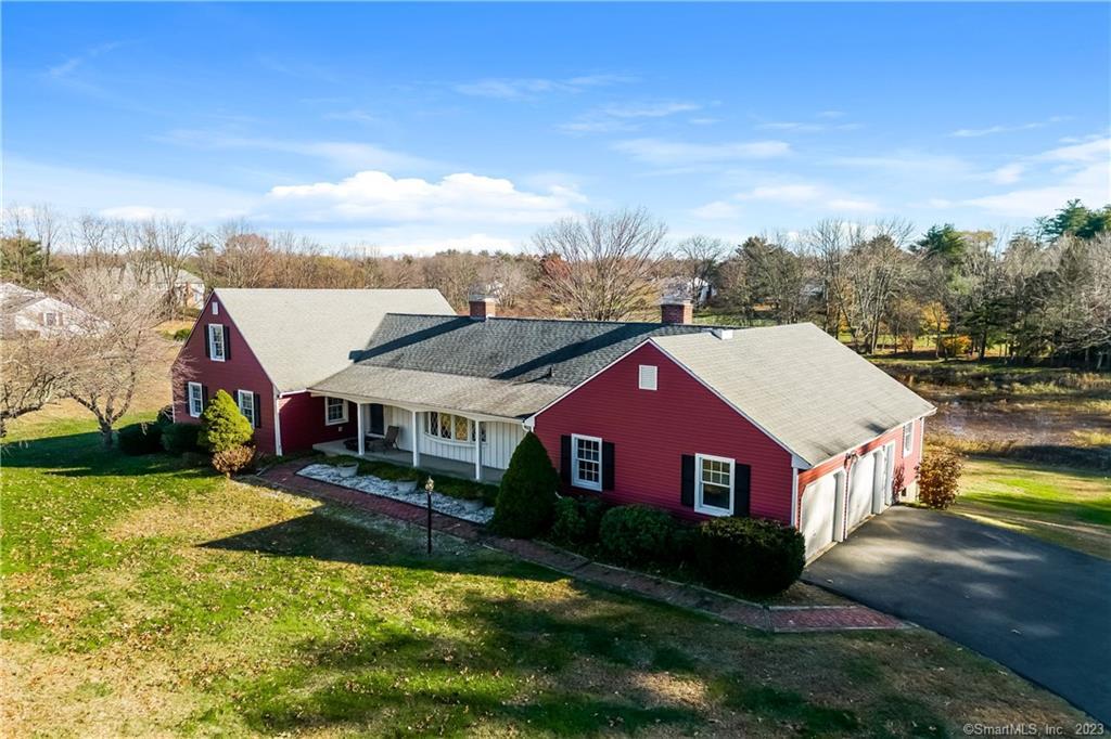 34 Old Farms Road Simsbury, CT 06092 - Photo 1 of 1 a aerial view of a house next to a yard with plants and large tree