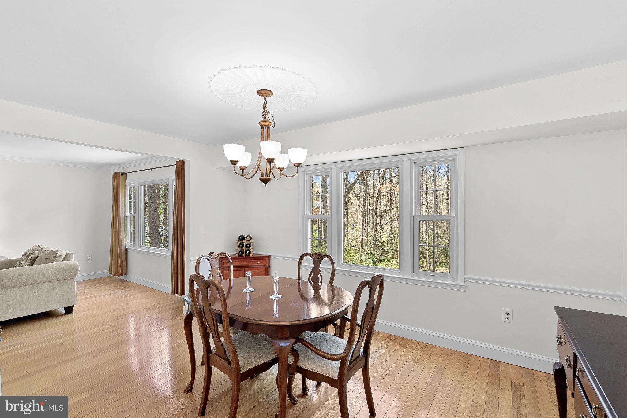 2804 Bree Hill Road Oakton, VA 22124 - Photo 16 of 46 a view of a dining room with furniture window and wooden floor