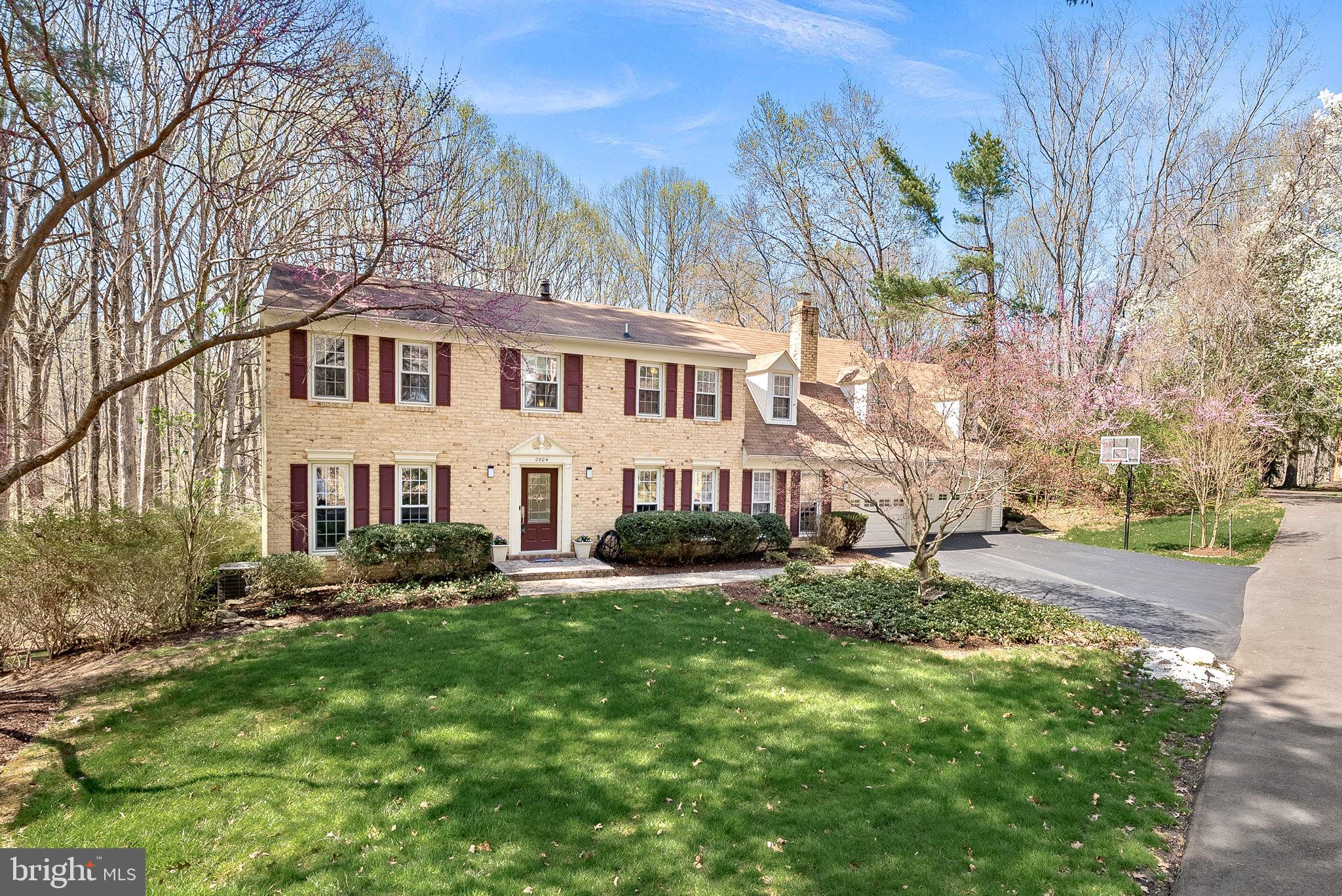 2804 Bree Hill Road Oakton, VA 22124 - Photo 2 of 46 a front view of a house with a garden and trees