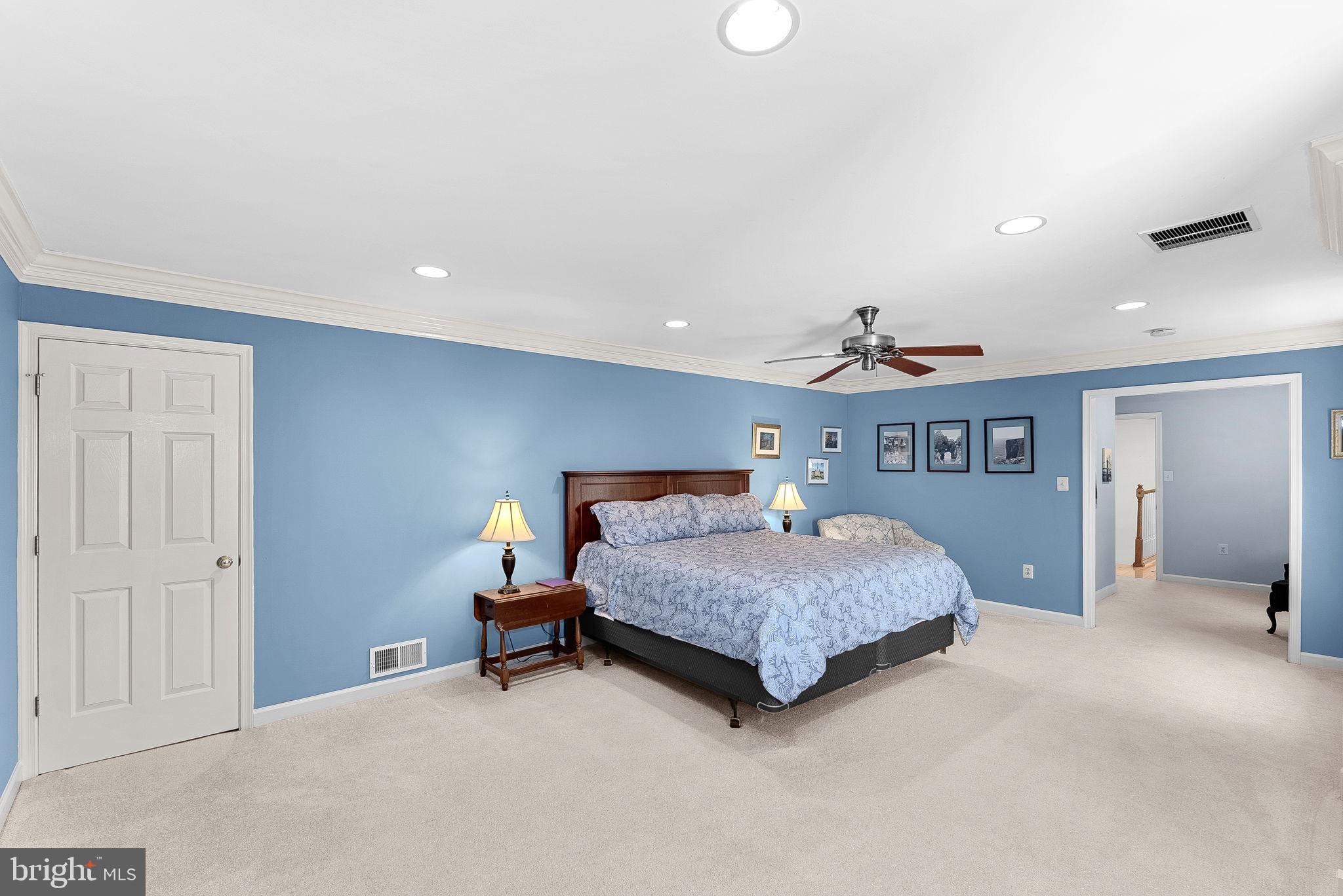 2804 Bree Hill Road Oakton, VA 22124 - Photo 21 of 46 a bedroom with a bed and a chandelier
