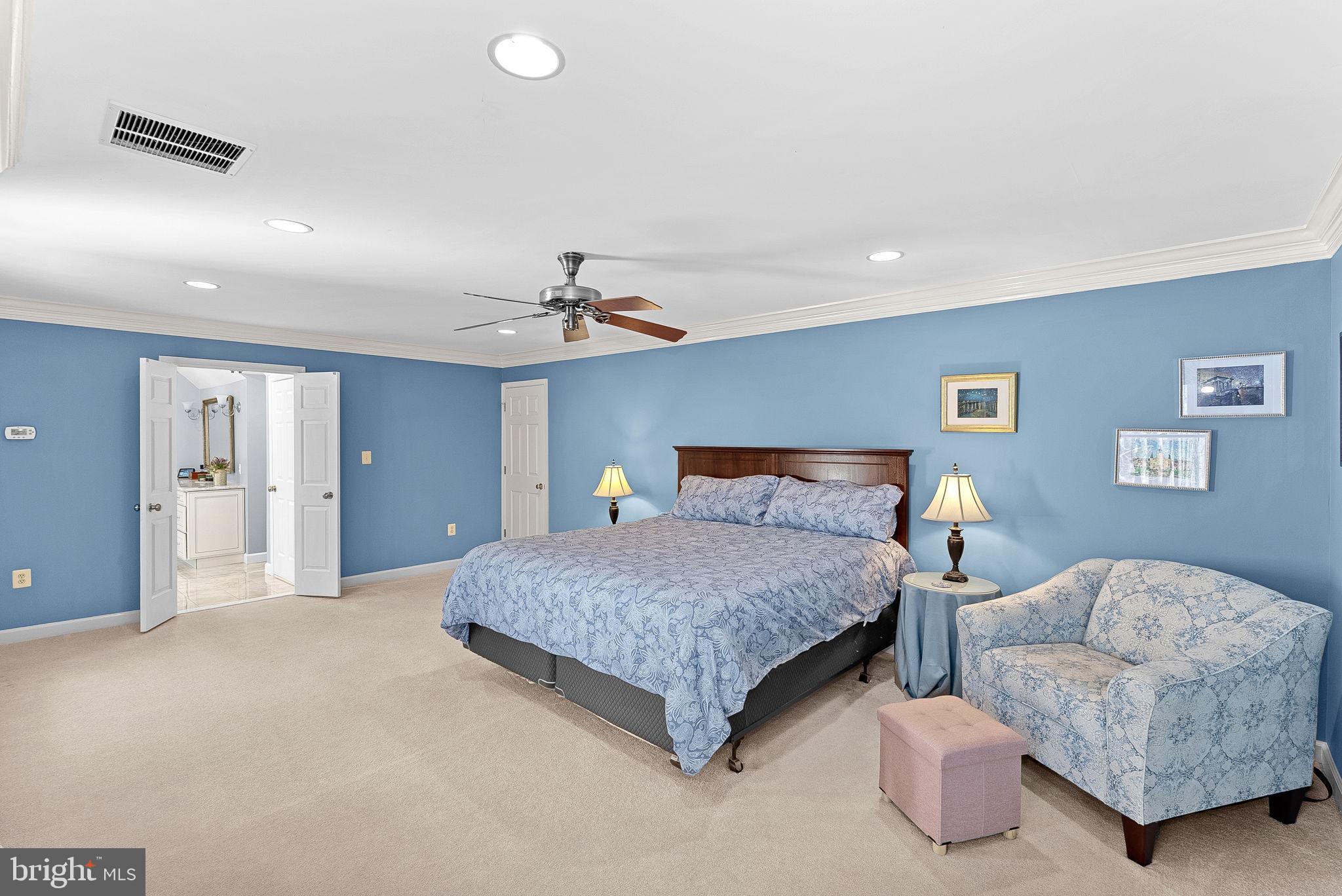 2804 Bree Hill Road Oakton, VA 22124 - Photo 22 of 46 a spacious bedroom with a bed and a couch