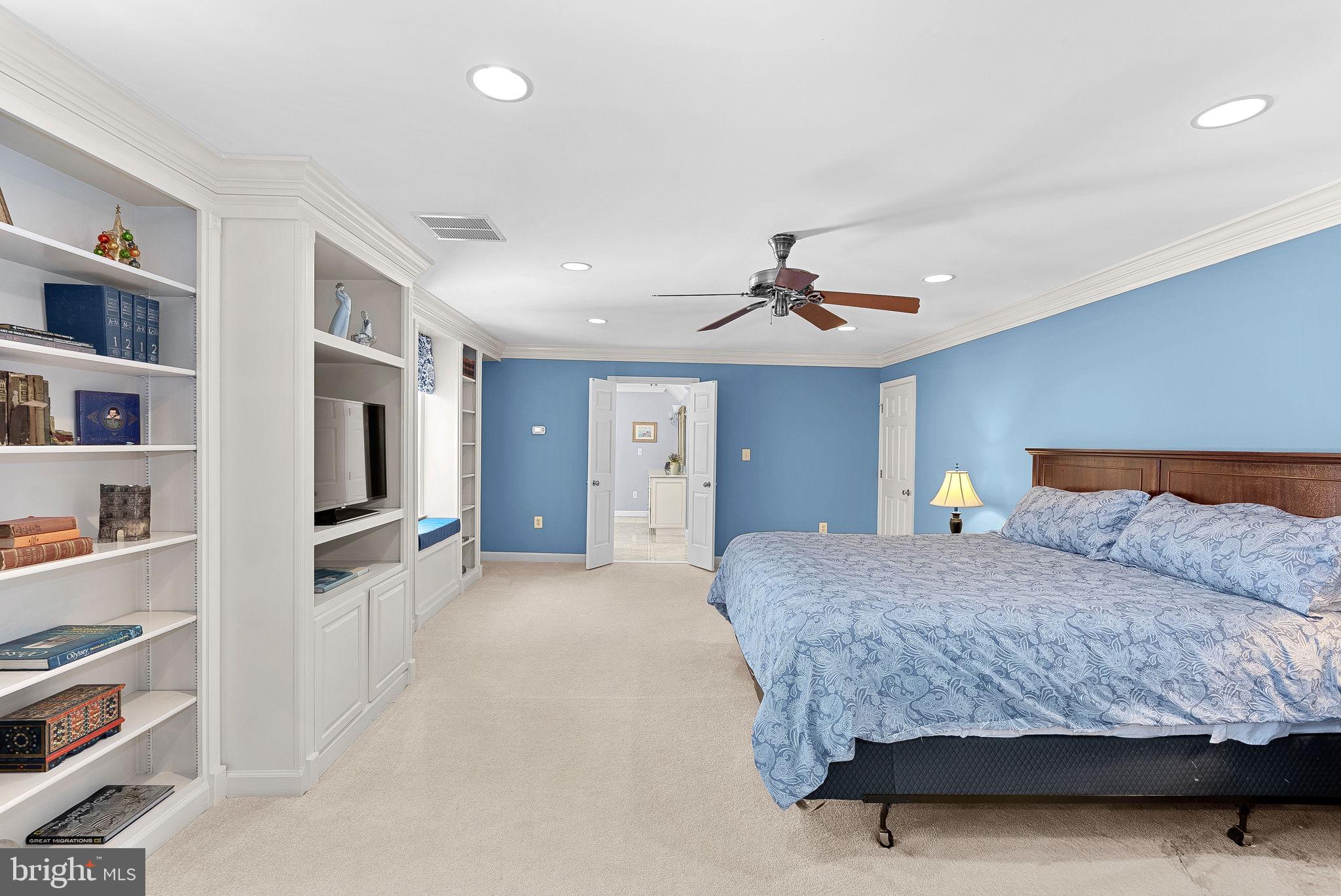 2804 Bree Hill Road Oakton, VA 22124 - Photo 23 of 46 a bedroom with a large bed a flat tv screen and closet