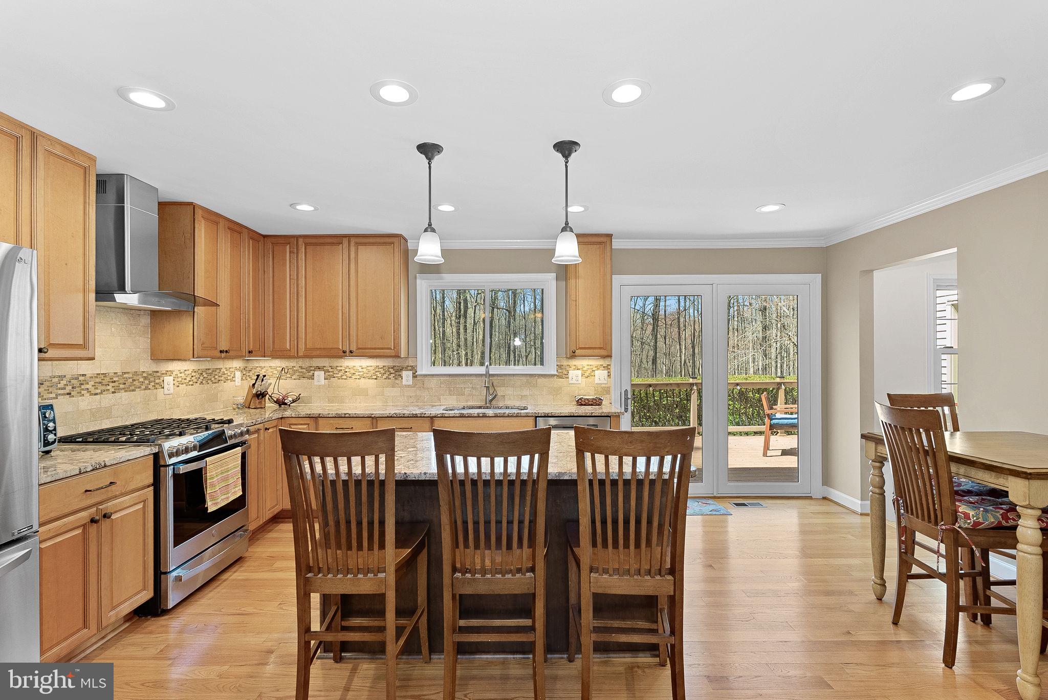 2804 Bree Hill Road Oakton, VA 22124 - Photo 7 of 46 a large kitchen with a table and chairs