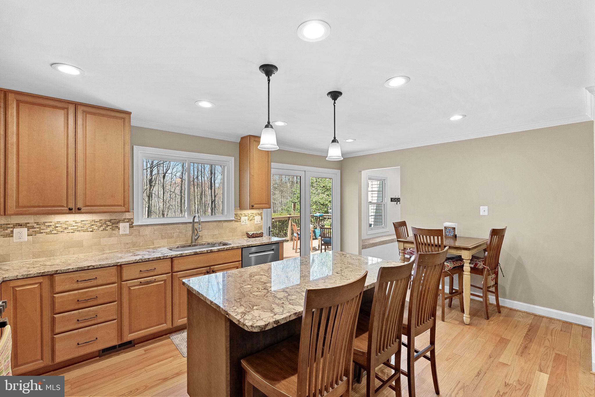 2804 Bree Hill Road Oakton, VA 22124 - Photo 8 of 46 a kitchen with granite countertop sink dining table and chairs