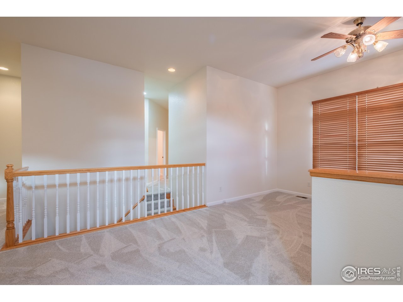 4313 29th Street Road Greeley, CO 80634 - Photo 5 of 31 Airy front greeting area with volume ceilings, classic railing detail, and brand-new carpet; paint touch-ups add polish.