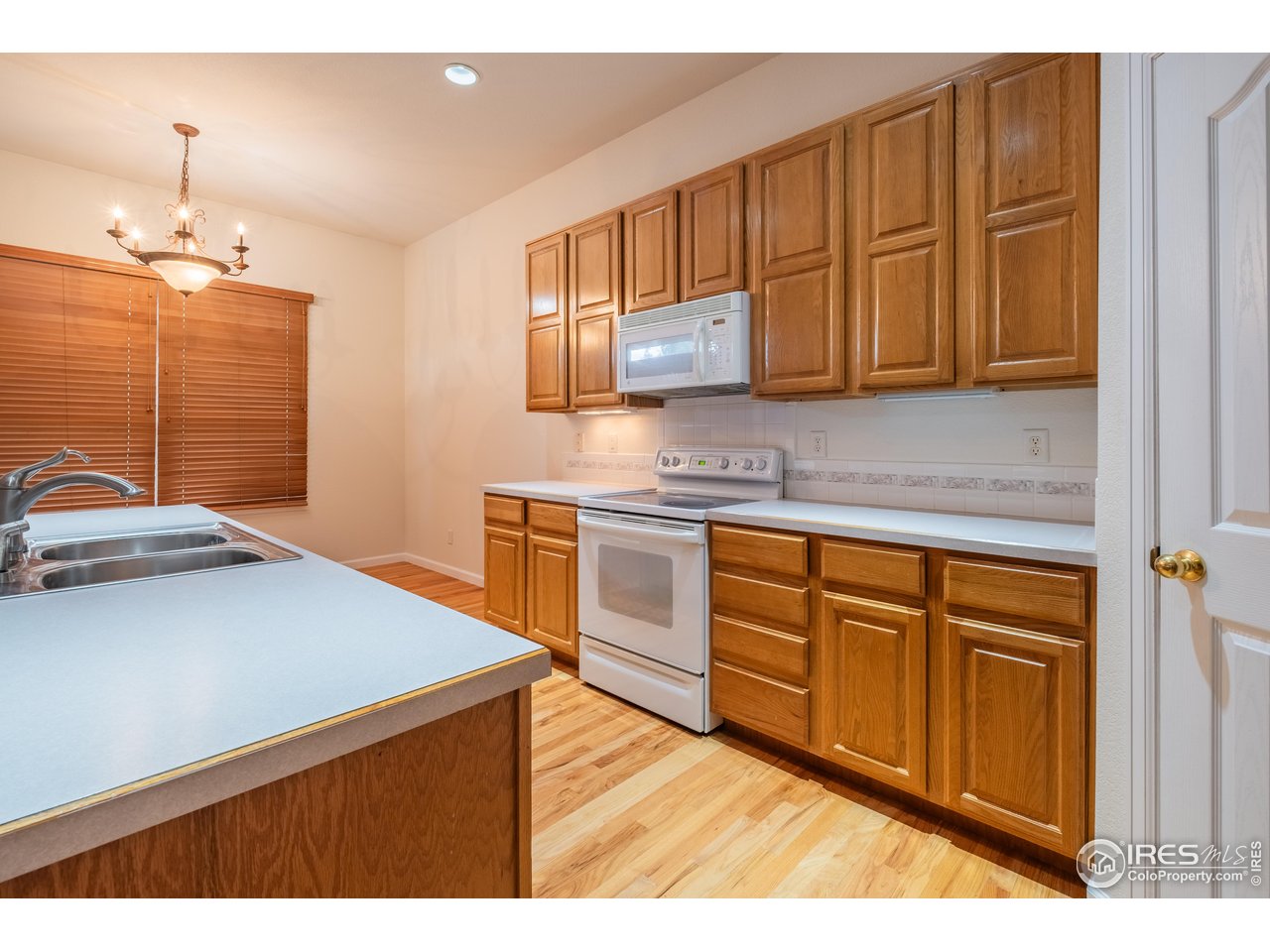 4313 29th Street Road Greeley, CO 80634 - Photo 9 of 31 Classic oak kitchen with abundant cabinetry and an adjoining dining niche-ideal for everyday gatherings.