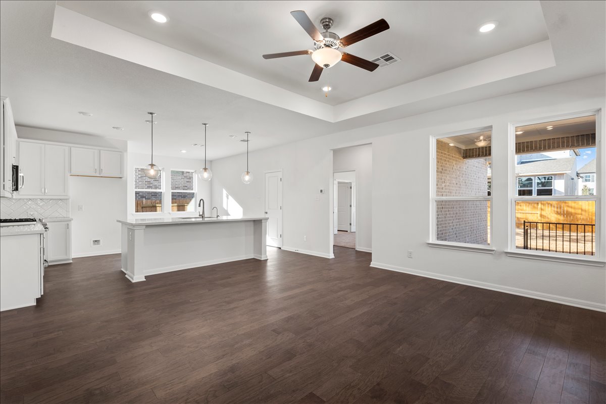 133 Grn Knl Lane Georgetown, TX 78628 - Photo 11 of 31 a view of an empty room with a window and wooden floor