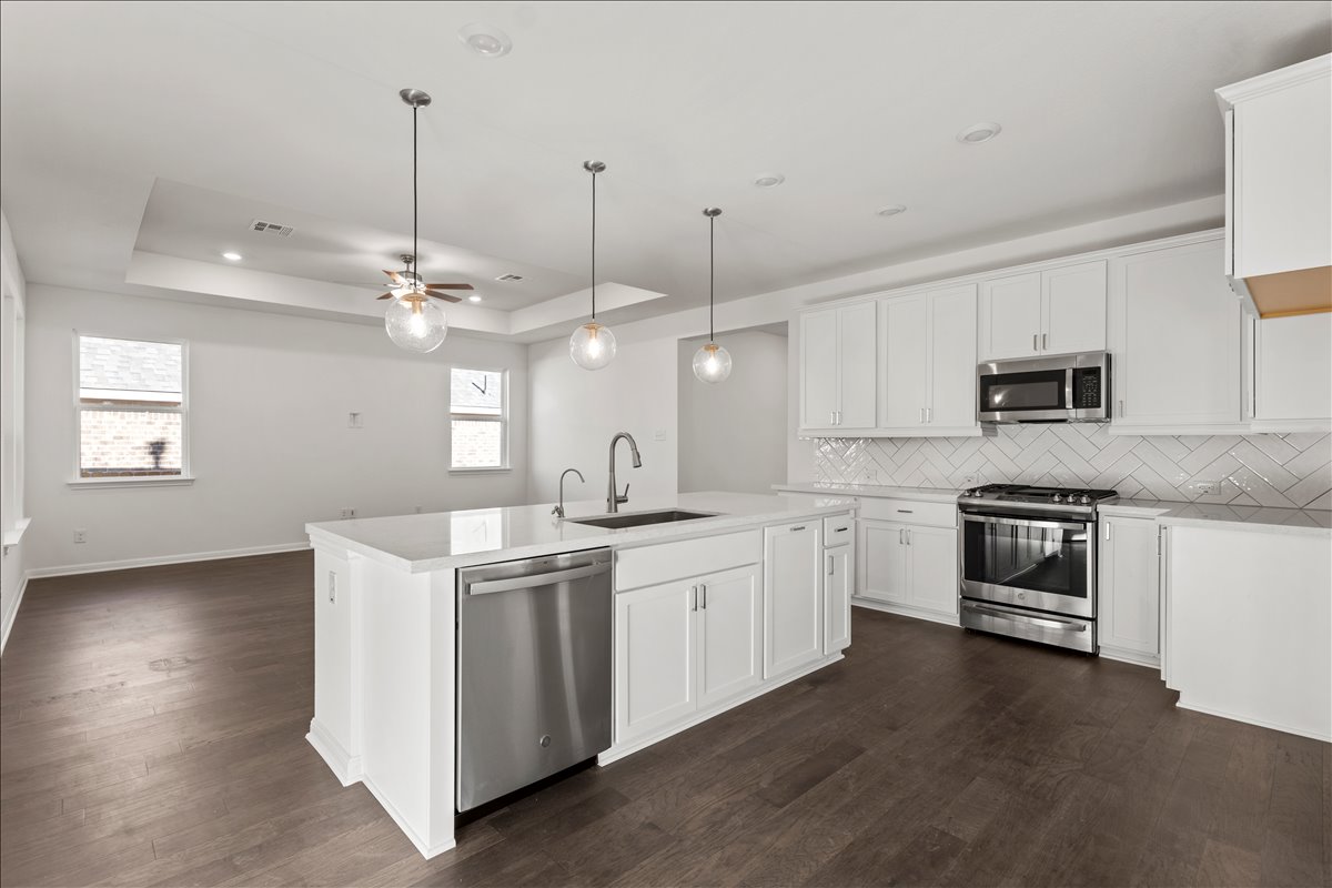 133 Grn Knl Lane Georgetown, TX 78628 - Photo 12 of 31 a kitchen with a stove oven and sink