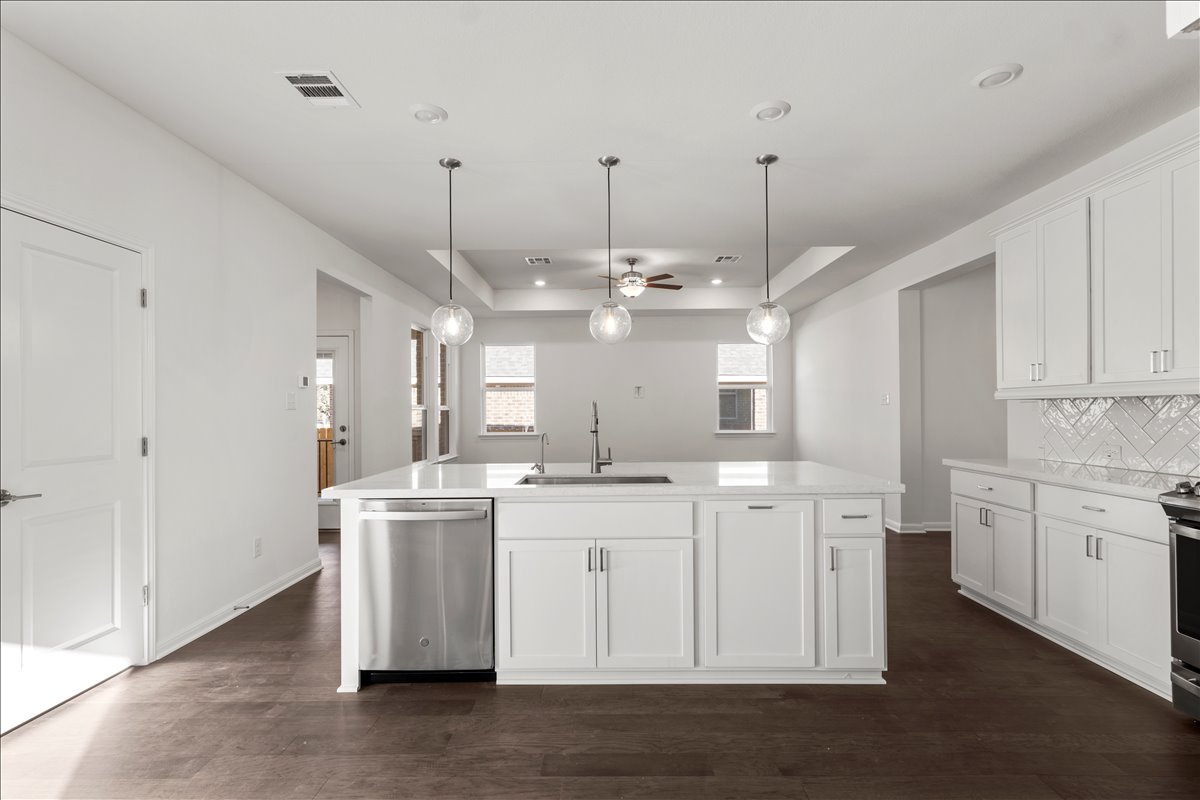 133 Grn Knl Lane Georgetown, TX 78628 - Photo 15 of 31 a kitchen with kitchen island white cabinets and refrigerator