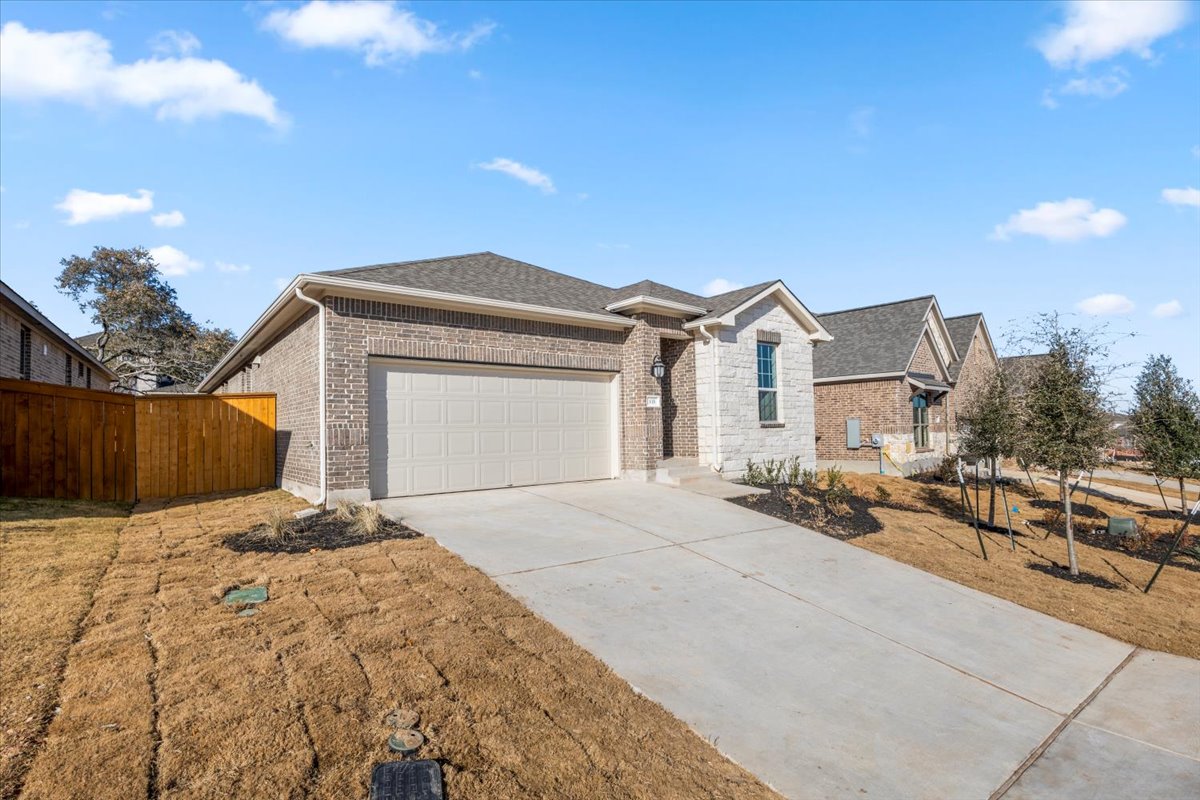 133 Grn Knl Lane Georgetown, TX 78628 - Photo 3 of 31 a front view of a house with a yard and garage