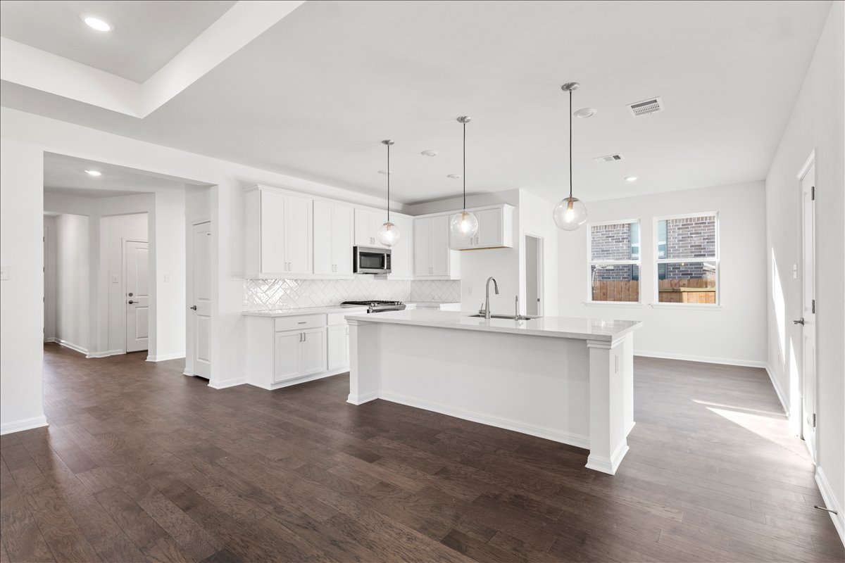 133 Grn Knl Lane Georgetown, TX 78628 - Photo 9 of 31 a large white kitchen with lots of counter space a sink appliances and cabinets