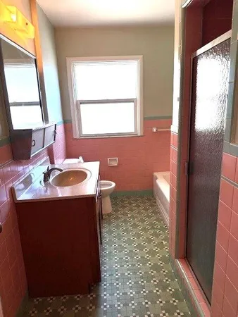 a bathroom with a sink a toilet and a mirror
