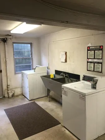 a living room with dryer and washer