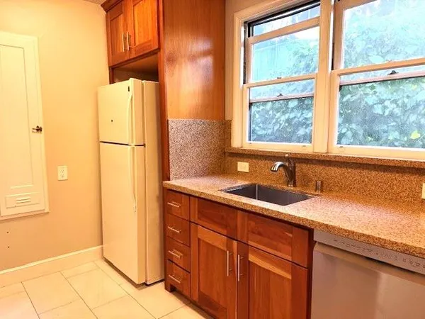 a kitchen with a refrigerator and a sink