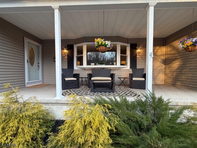 a view of a house with sitting area and garden