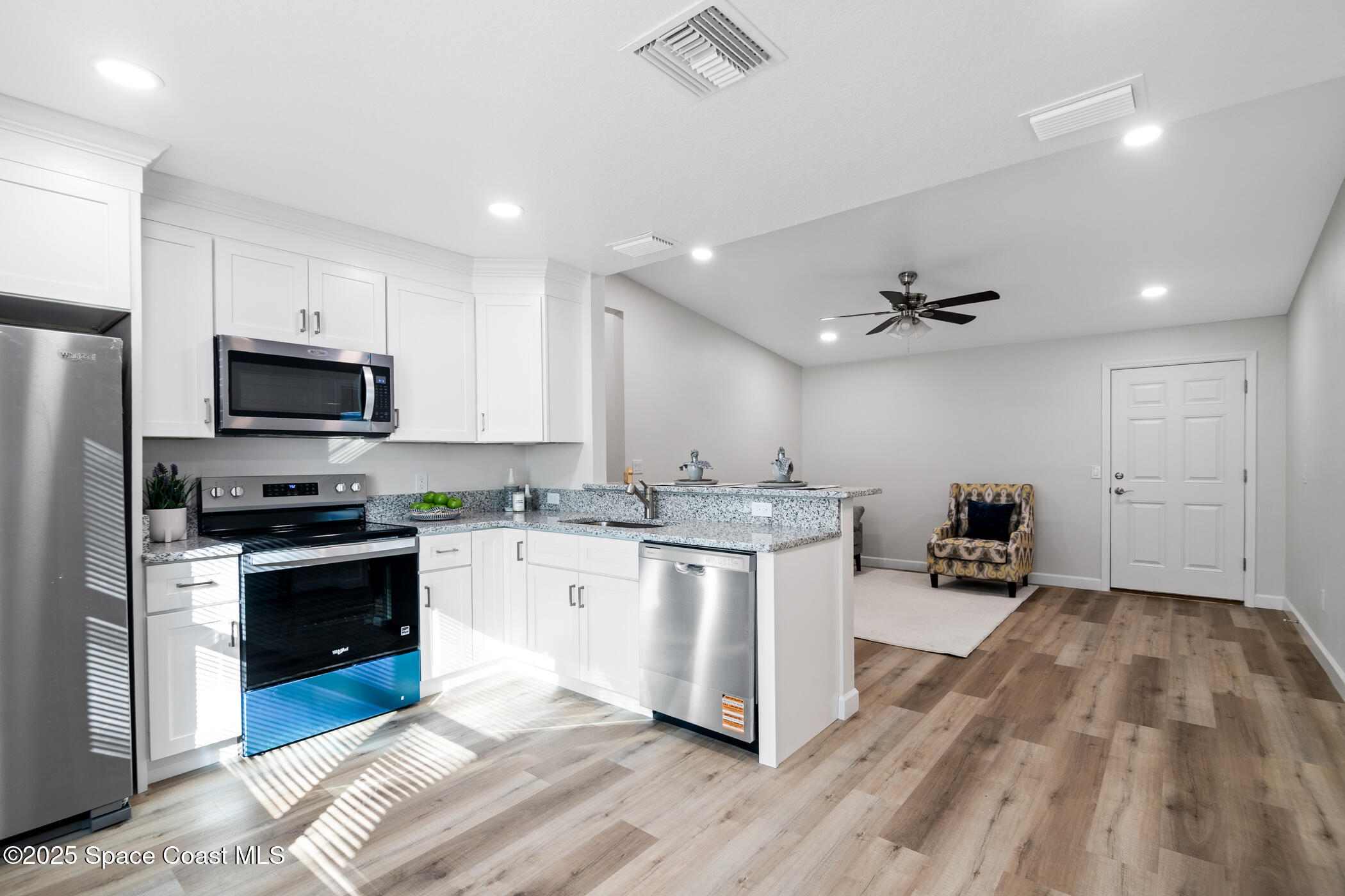 1107 Abington Street Cocoa, FL 32922 - Photo 12 of 20 a kitchen with sink a microwave and cabinets